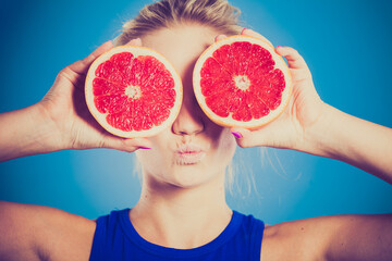 Woman holding grapefruit citrus fruit in hands