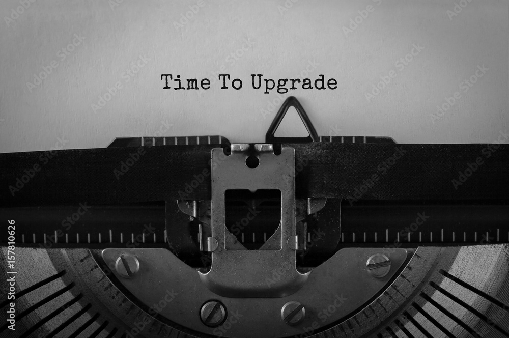 Poster text time to upgrade typed on retro typewriter