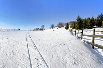 Fototapeta premium A Pastoral Scene Of Snow Covered Fences, Trees And Walking Paths trails