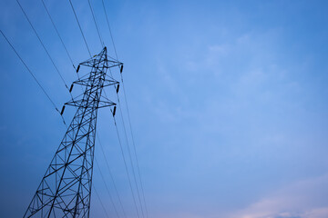 Fototapeta premium Silhouette of high voltage pole and sunset