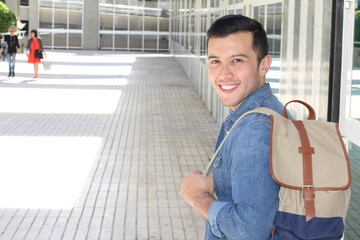 Fototapeta premium Motivated student holding books at school