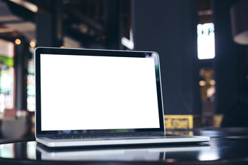 Mockup image of laptop with blank white screen on wooden table in coffee shop