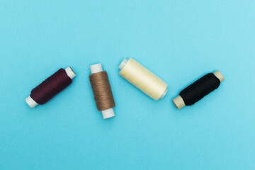 Old rolls of thread on a blue background.