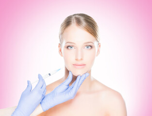 Young, beautiful and healthy woman having skin injections over pink background. Plastic surgery concept.