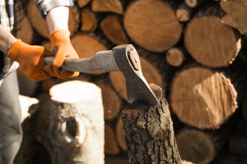Firewood for the fireplace, barbecue. A man chopping wood for a barbecue. Folded firewood