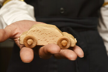 Wooden car on hand
