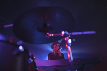 Female performing on stage in illuminated nightclub