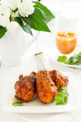 Roasted chicken legs with barbecue sauce with mango chutney.
