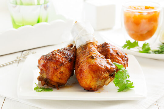 Roasted chicken legs with barbecue sauce with mango chutney.
