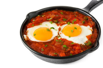 Mexican breakfast: Huevos rancheros in iron frying pan isolated on white background
