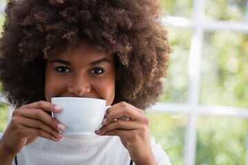 Close up portrait of smiling woman having coffee in cafe