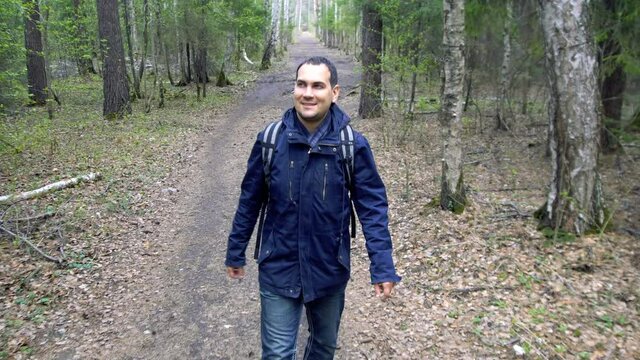 Man Walking in Spring Forest