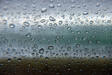 Drops of water on a gray background. Close-up.