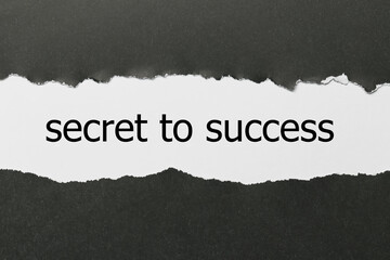 secret to success written under torn paper