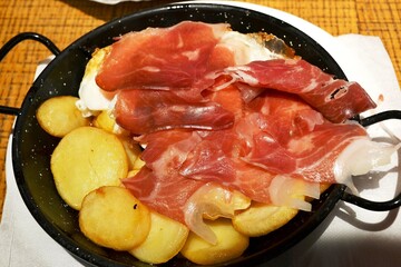 A dish of ham and potatoes.