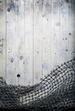 Fishing nets still-life on the wooden background.