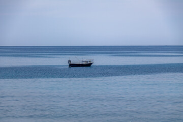Obraz premium A boat in a Mediterranean beach of Ionian Sea - Bova Marina, Calabria, Italy