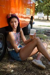 Woman sitting with a glass of beer in the park