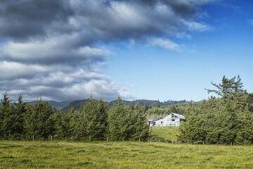 High Dynamic Range Image of a barn and clouds and trees
