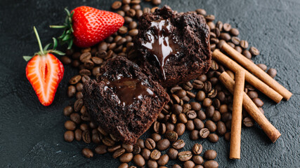 Muffin on a dark background with coffee beans and strawberries