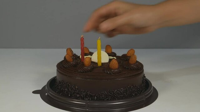 4k Of Happy Birthday cake with burning spiral candles in dark