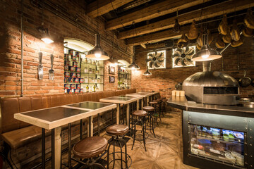 Interior of pizza restaurant with wood fired oven