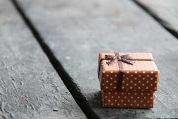Gift box on white wood table. With a lot of copy space.