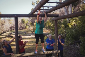 Woman being cheered by her teammates - Powered by Adobe