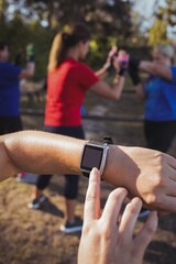 Hands of women using smartwatch in the boot camp