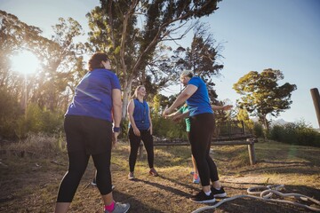 Group of fit women standing together in the boot camp