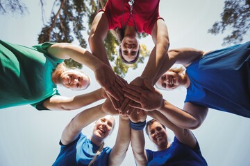 Group of women forming hand stack in the boot camp