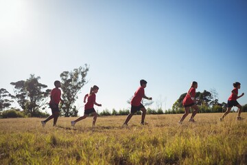 Group of kids jogging in the boot camp