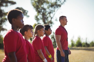 Trainer training kids in the boot camp