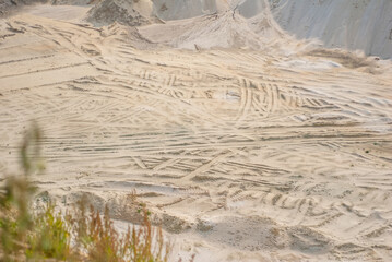 industrial sand quarry, sand pit, tyre tracks in sand, sand background, natural yellow abstract