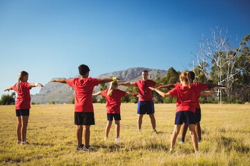 Trainer training kids in the boot camp