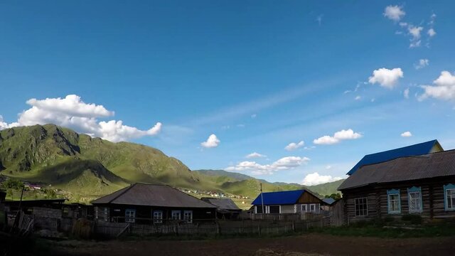 Blue sky with clouds over rural buildings