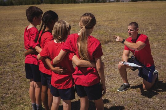 Trainer instructing kids in the boot camp