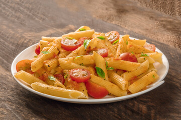 Penne pasta with tomato sauce and fresh basil leaves