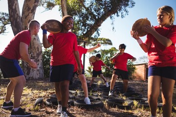 Trainer instructing kids during obstacle course training