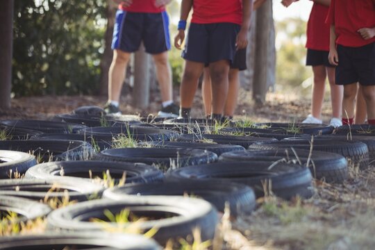 Kids standing in the boot camp during obstacle course training - Powered by Adobe