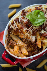 Close-up of italian traditional ziti in a baking dish, vertical shot, selective focus
