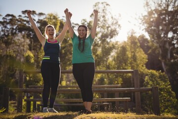 Happy friends cheering during obstacle course