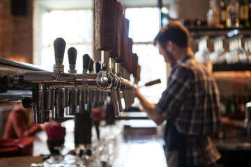 A lot of Golden beer taps at the bar