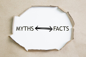 The text Facts vs myths appearing behind torn brown paper