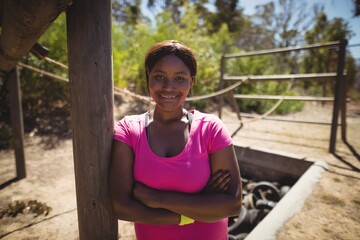 Portrait of happy woman standing with arms 