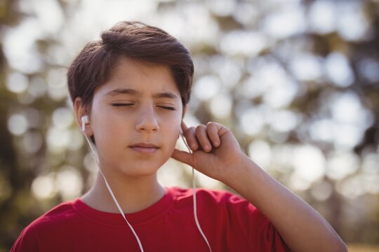 Close-up of boy listening music on headphones