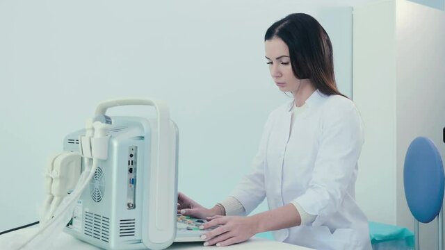 A woman works with an ultrasound device in clinic