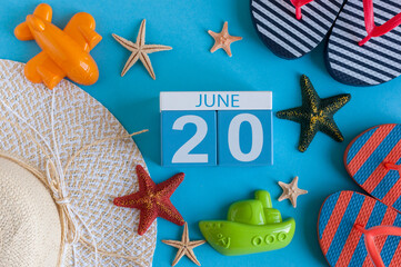 June 20th. Image of june 20 calendar on blue background with summer beach, traveler outfit and accessories. Summer day