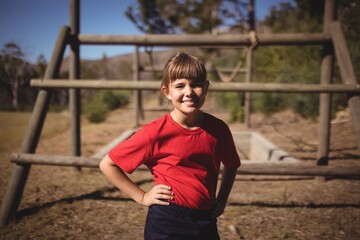 Obraz premium Portrait of happy girl standing with hands on hip 