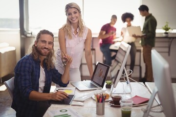 Portrait of smiling business colleagues working 